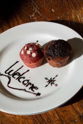 a plate with a chocolate muffin and a happy new year at Amed Cafe & Hotel Kebun Wayan in Amed