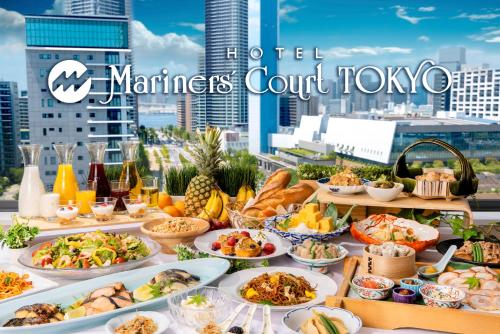 a buffet of food with a view of the city at Hotel Mariners Court Tokyo in Tokyo