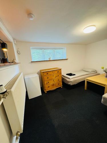 a small room with a bed and a dresser in it at Casa de Rainer Copenhagen Room 2 in Copenhagen