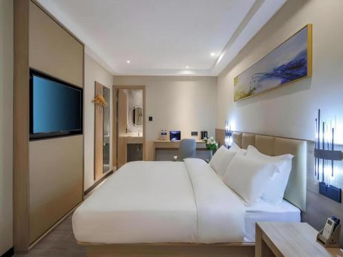 Ένα ή περισσότερα κρεβάτια σε δωμάτιο στο Green Tree Inn Nanjing Xinjiekou Wangfu Avenue