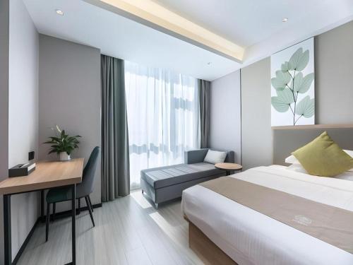 ein Schlafzimmer mit einem Bett, einem Schreibtisch und einem Stuhl in der Unterkunft Green Tree Inn Suzhou Wujiang East Tai Lake Tourism Resorts in Suzhou
