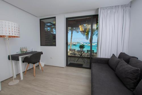 a living room with a couch and a table at Golden Bay Galapagos in Puerto Baquerizo Moreno