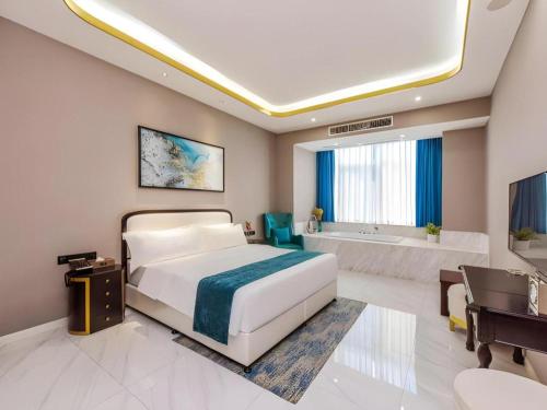 a bedroom with a bed and a tub and a sink at GEM Hotel Chengdu Chunxi Road Taiguli in Chengdu