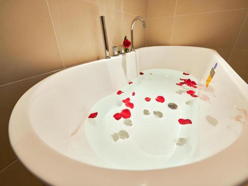 a white bath tub with red hearts on it at Lavande Hotel Changchun Gaoxin Jilin University in Changchun