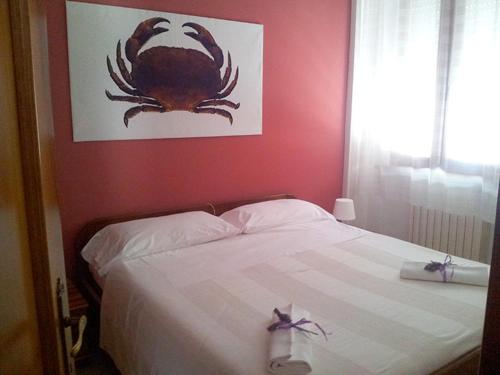 a bedroom with a bed with a crab picture on the wall at Residence MareVerde in Senigallia