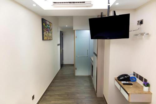 a room with a hallway with a television on the wall at Metroplace Boutique in Hong Kong