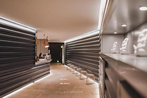 a hallway with a row of chairs in a store at Pakchong Center Poshtel in Mu Si
