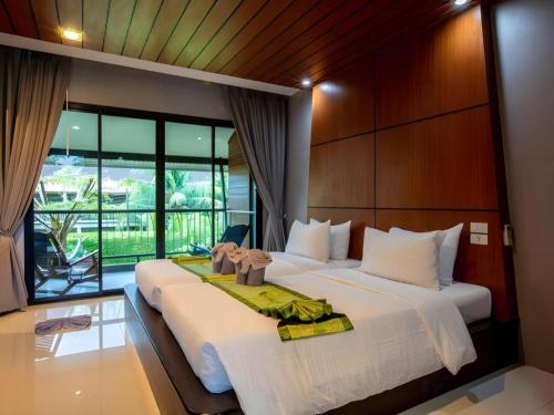 a bedroom with a large bed with a large window at The Breeze Lipe Resort in Ko Lipe