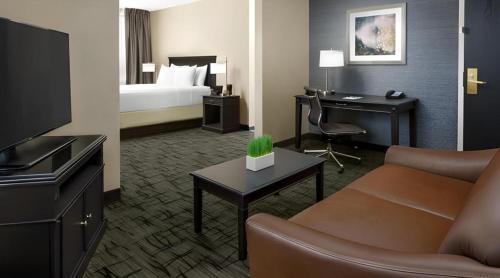 a hotel room with a bed and a desk at Valley Forge Casino Resort in Betzwood