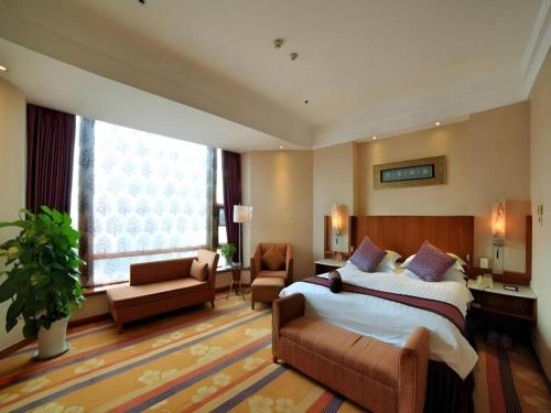 a bedroom with a large bed and a living room at Gem Flower Jinyu Sunshine Hotel in Chengdu