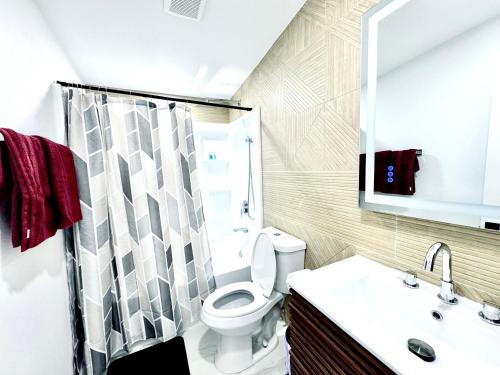 a bathroom with a toilet and a sink and a shower at Xlnc Exotic home13824 Powers Rd in Poway