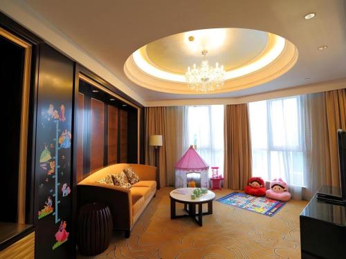 a living room with a couch and a table at Royal Tulip Hotel Zhujiajiao Shanghai in Shanghai