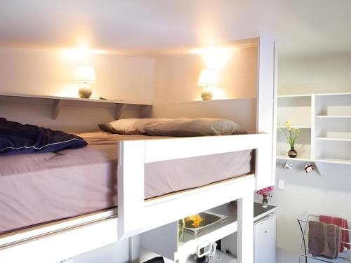 a bedroom with a bunk bed with lights on at Stables Lodge Backpackers in Napier