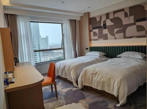 Zhangjiagang Guomao Hotelにあるベッド