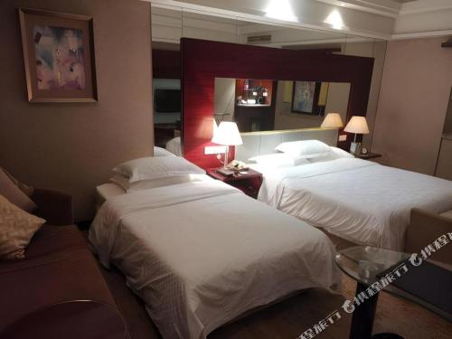 Zhangjiagang Guomao Hotelにあるベッド