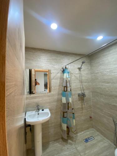 a bathroom with a sink and a shower at Abc Appart in Saidia 