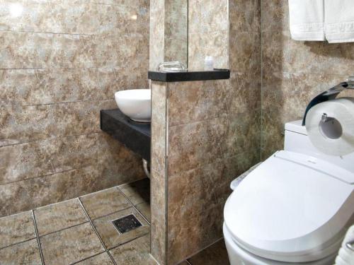 a bathroom with a toilet and a sink at BENIKEA Technovalley Hotel in Daejeon