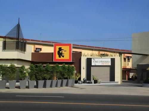 a building with a sign on the side of a street at One Serenata Hotel General Trias in Silang