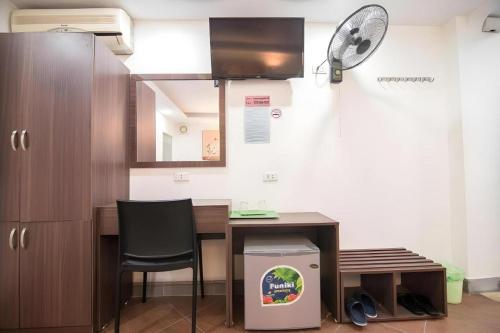 a kitchen with a table and a fan at Ha Noi Vang Hotel Hoang Ngan in Hanoi