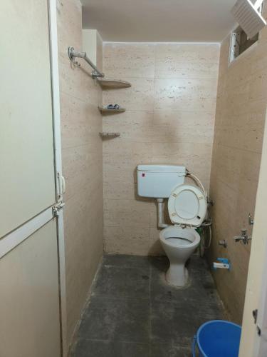 a small bathroom with a toilet in a room at Shree Vinayak Stay in Ujjain