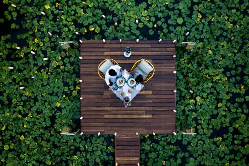 an overhead view of a heart shaped sign in a field of flowers at Fusion Resort Cam Ranh - All Spa Inclusive in Cam Ranh