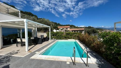 a swimming pool in the backyard of a house at Le Villette in Cittadella del Capo