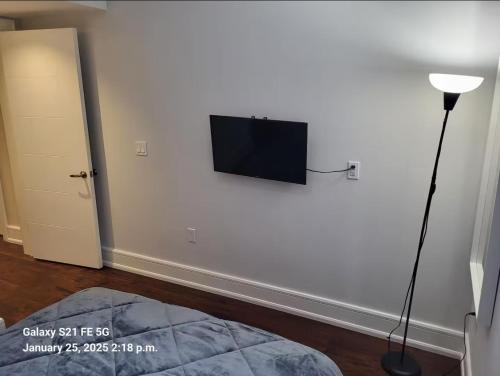 a room with a flat screen tv on a wall at Hillcrest Modern House in Toronto