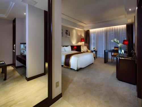 a hotel room with a bed and a desk at SUN Yat-sen university Hotel and Conference Centre in Guangzhou