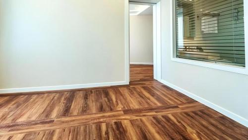 an empty room with wooden floors and a window at Galaxy Hotel in Jeju