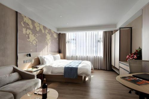 Postel nebo postele na pokoji v ubytování Shenzhen Hanyong Hotel Fuyong Branch