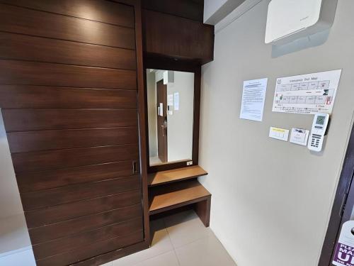 a room with a wooden door and some stairs at Wsotel Hotel in Songkhla