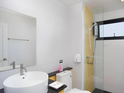 a bathroom with a sink and a toilet and a shower at Le Park Hotel in Nakhon Si Thammarat