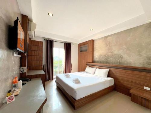 a hotel room with a bed and a television at B2 Buriram Boutique and Budget Hotel in Ban Khok Wat