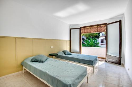 a hospital room with two beds and a window at Pescadors in Pals