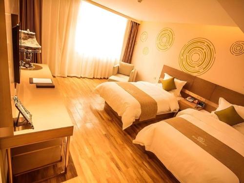 a hotel room with two beds and a window at GreenTree Inn Xi'an Yanta District Dayanta Furongyuan Hotel in Xi'an
