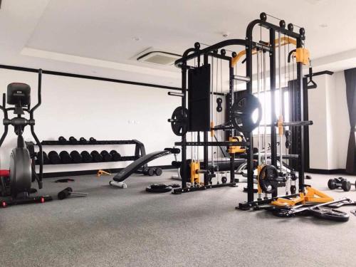 a room with a gym with a treadmill and other equipment at Lao Home in Vientiane