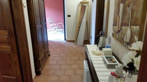 a hallway of a room with a table and a chair at Villa Laura B&B in Fossano