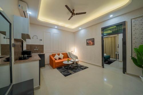 a living room with a couch and a ceiling fan at Aalaya Suites By Perfect Stayz in Haridwār