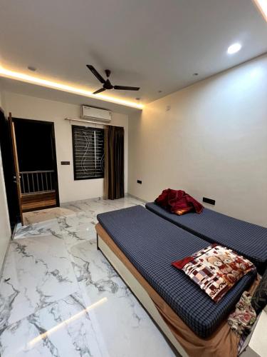a bedroom with a bed in a room with marble floors at BluSplash Private Pool Villa in Lakāwās