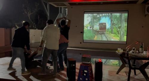 a group of people playing a video game on a screen at BluSplash Private Pool Villa in Lakāwās