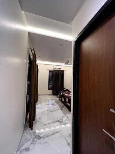 a room with a hallway with marble floors and a door at BluSplash Private Pool Villa in Lakāwās