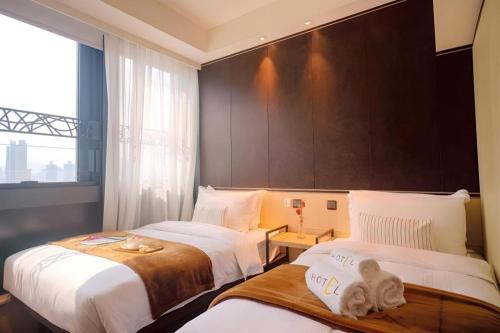 a hotel room with two beds and a large window at Ehotel in Hong Kong