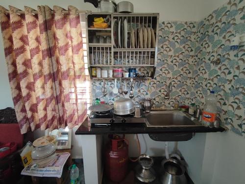 a kitchen with a sink and a counter top at Mountain View Stay in Kushālnagar