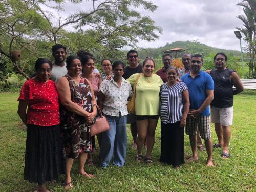 a group of people posing for a picture in a field at Handiranwila Jay Resort in Anguruwatota