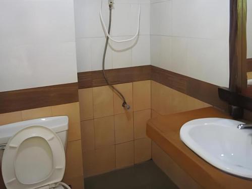a bathroom with a toilet and a sink at Phuttachot Resort in Phi Phi Don