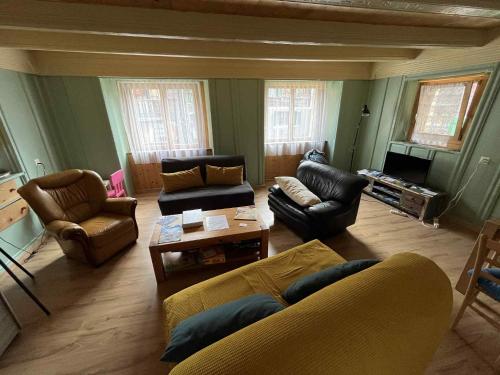 a living room with a couch and chairs and a table at Historische Maisonettewohnung bis 10 Gäste, Magic Pass Belalp, Rosswald und mehr in Naters