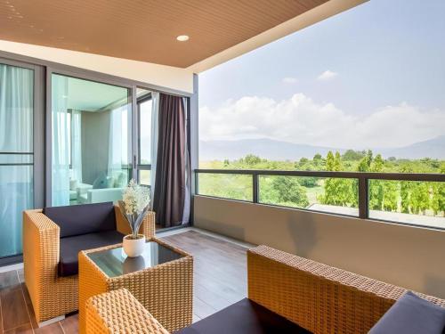 a living room with a couch and a table at Green Valley Executive Serviced Residence in Chiang Mai