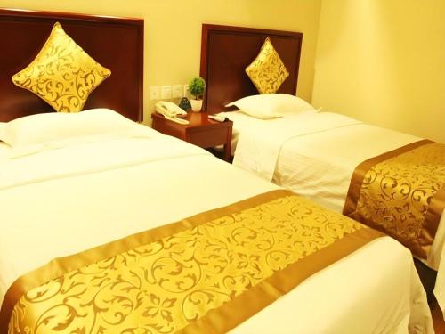 Ένα ή περισσότερα κρεβάτια σε δωμάτιο στο GreenTree Inn Hebei Zhangjiakou Xiahuayuan Xinchen Road Express Hotel