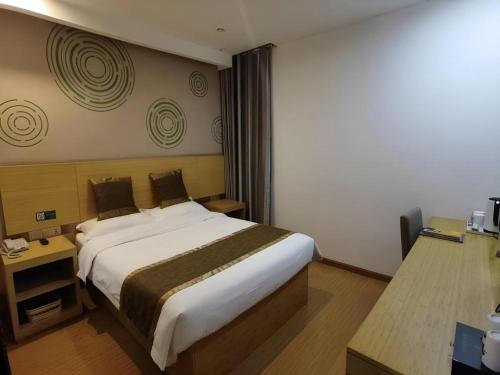 a bedroom with a large bed in a room at GreenTree Inn Shanghai Fengxian District Xiaotang Metro Station in Shanghai