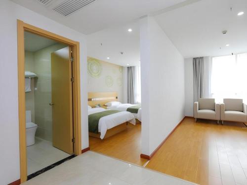 a hotel room with two beds and a bathroom at GreenTree Inn Jiaxin Puyuan Kaixuan Road in Jiaxing